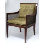 A mahogany bergere chair with upholstery Please Note - we do not make reference to the condition
