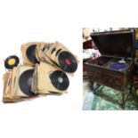 An oak cased wind up gramophone. Together with a quantity of records Please Note - we do not make