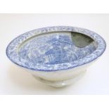 A Victorian water closet bowl / pan with blue and white transfer decoration depicting figures in a