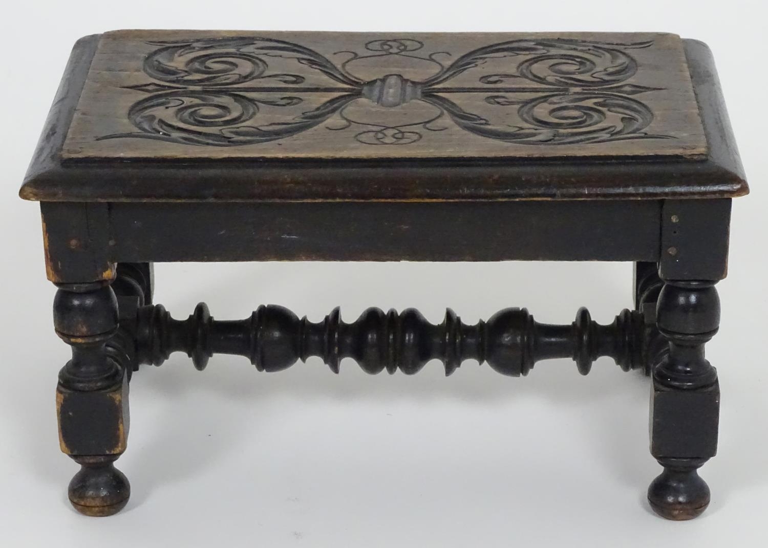 An early 20thC footstool with a carved top above four turned legs united by a H-stretcher. 13" - Image 3 of 3