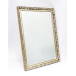 A modern gilt framed mirror with floral decoration and bevelled edge glass Please Note - we do not