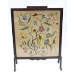 An early 20thC fire screen with embroidered panel Please Note - we do not make reference to the