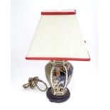 An Oriental style lamp with shade Please Note - we do not make reference to the condition of lots