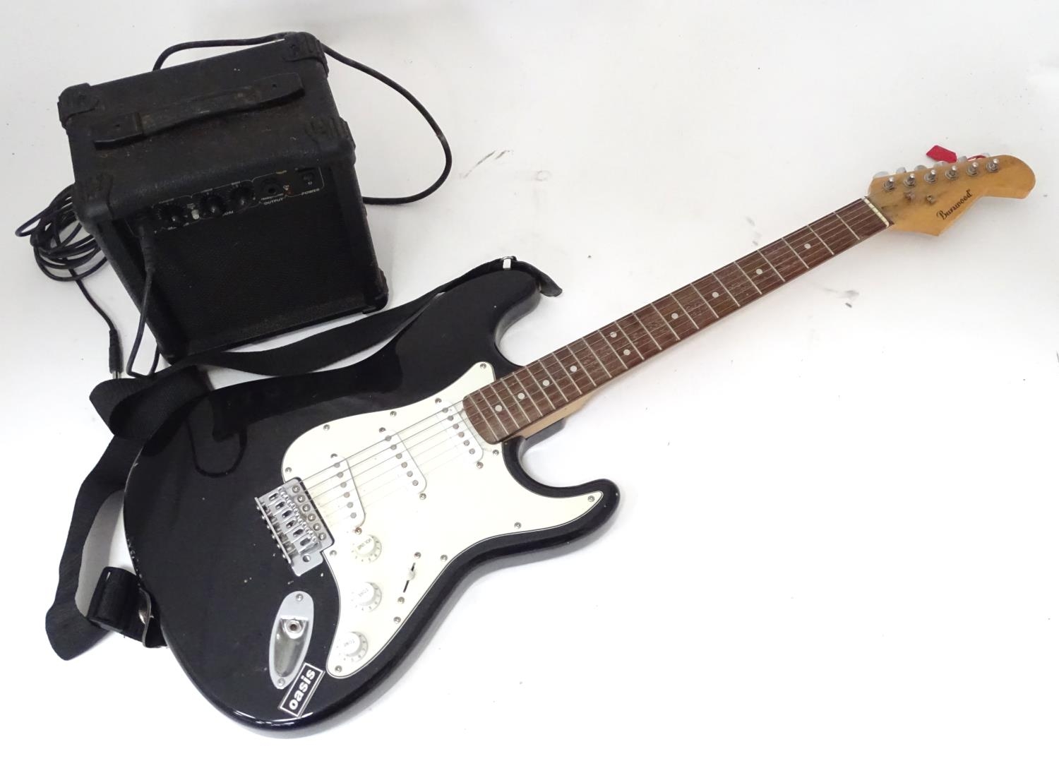 A Burswood stratocaster type guitar with small amplifier, leads, bag, etc. Please Note - we do not