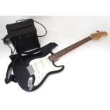 A Burswood stratocaster type guitar with small amplifier, leads, bag, etc. Please Note - we do not