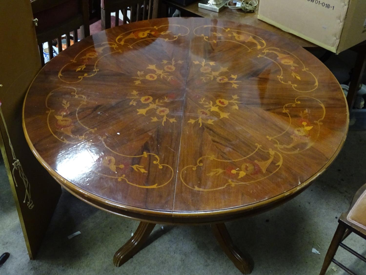 A circular mahogany inlaid dining table Please Note - we do not make reference to the condition of