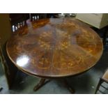 A circular mahogany inlaid dining table Please Note - we do not make reference to the condition of