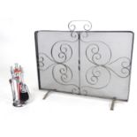 A 20thC spark guard / fire screen with wrought iron scrolling detail. Together with a small