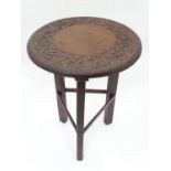 A tripod occasional table with carved top Please Note - we do not make reference to the condition of