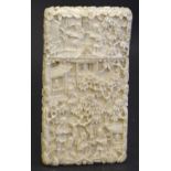 A Chinese carved ivory card case of rectangular form, carved with figures in garden landscapes and