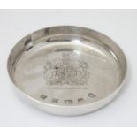 A QEII silver souvenir pin dish engraved with Royal coat of arms and titled ' The Queens Silver