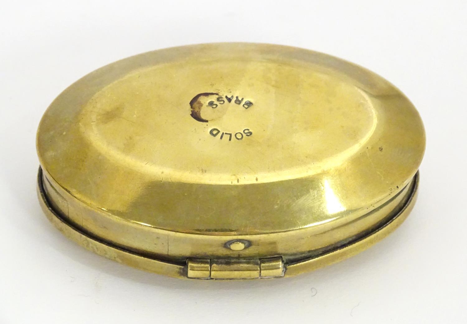 A Victorian brass snuff box of oval form, marked under Solid Brass. Approx. 1 3/4" x 2 3/4" Please - Image 4 of 16