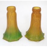 Two Art Nouveau light / lamp shades, of flared form, in gold amber and green with flecked detail. In