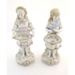 Two Continental bisque figures modelled as girls with floral baskets. Approx. 18" high (2) Please