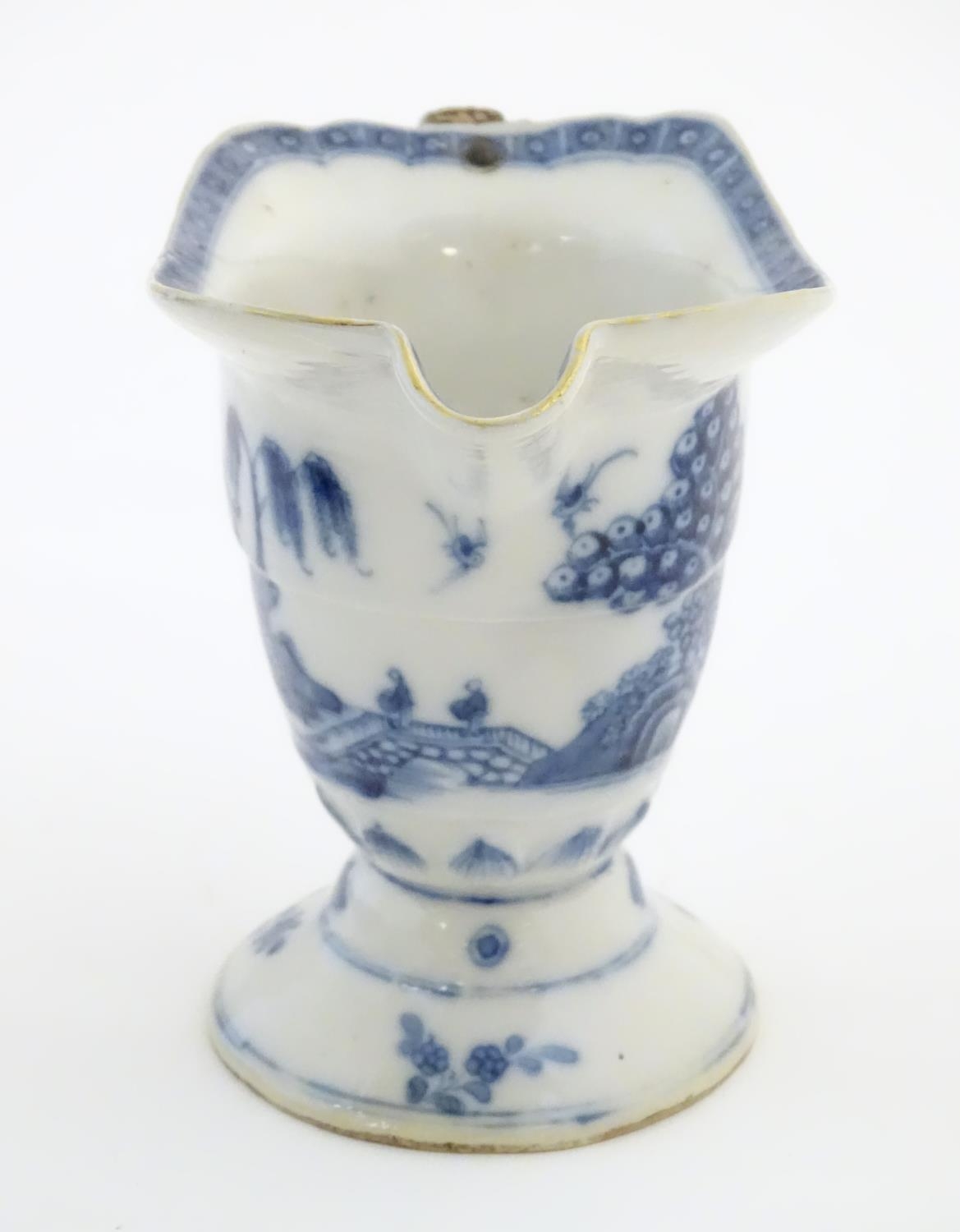 A helmet jug with blue and white decoration with a stylised landscape scene with pagodas, - Image 5 of 6