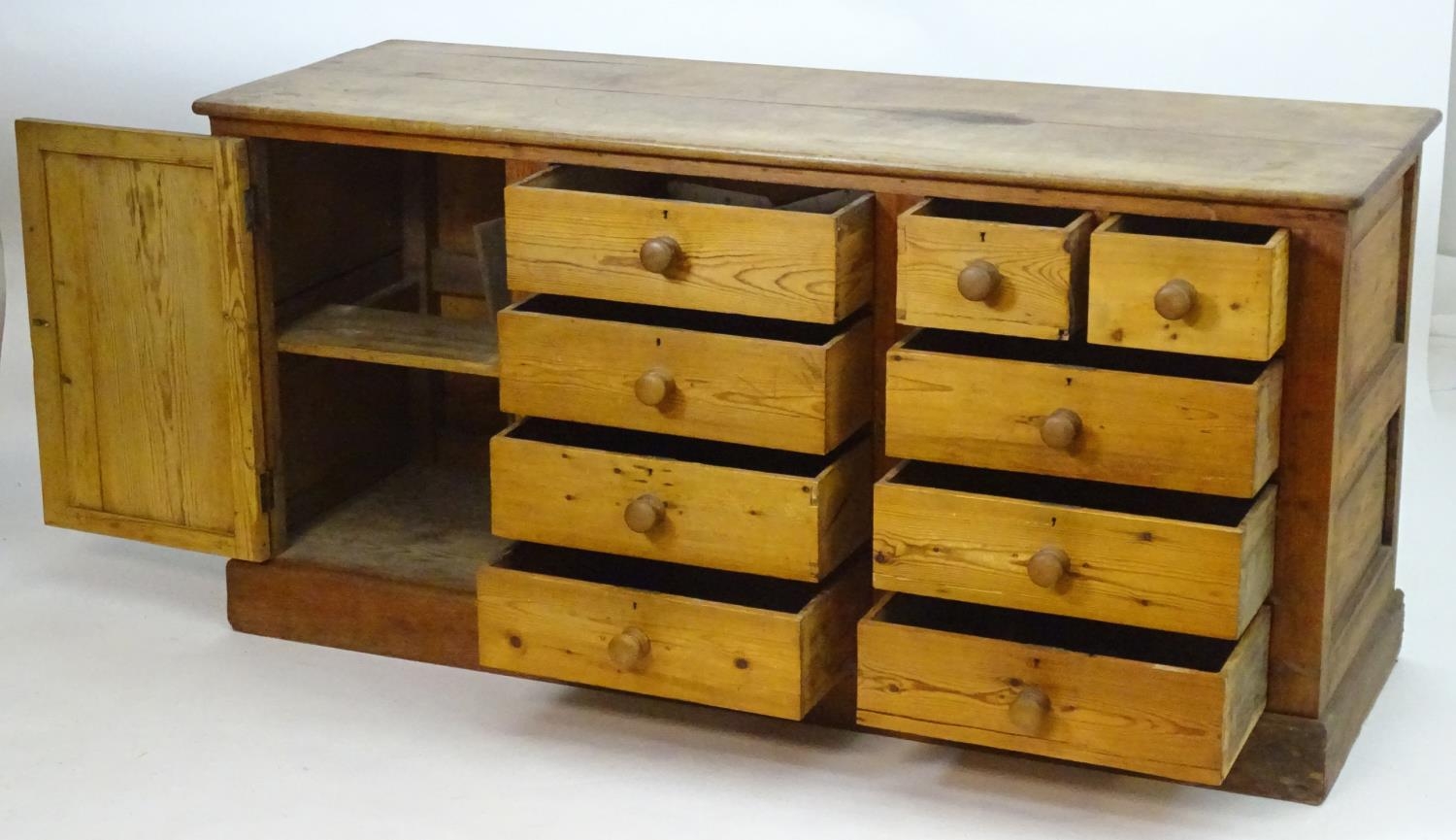 A late 19thC pine dresser base with a moulded rectangular top above a single cupboard, seven short - Image 4 of 7
