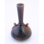 An Arts & Crafts Linthorpe style flambe bottle vase with a flared rim and styled twin handles.