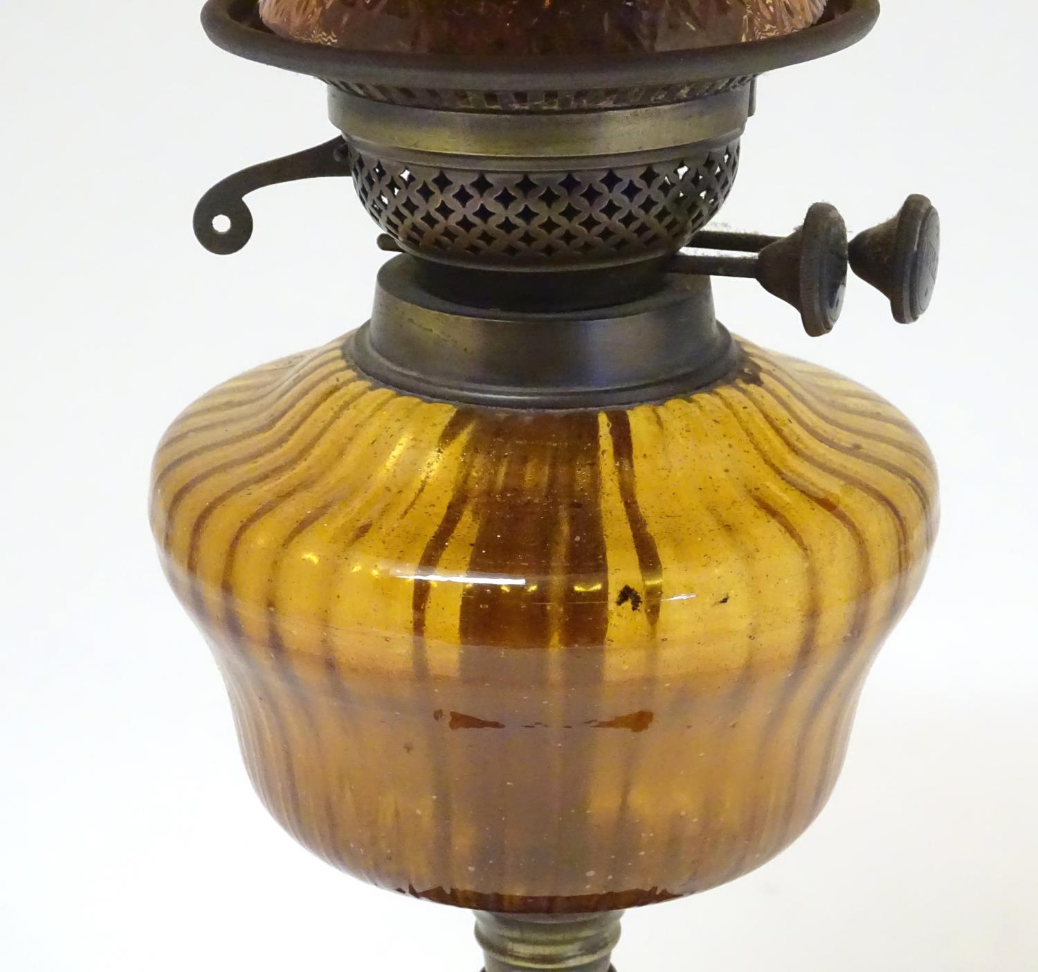 A late 19thC Duplex oil lamp, with bronzed glass shade and reservoir, standing on a cast iron base - Image 16 of 24
