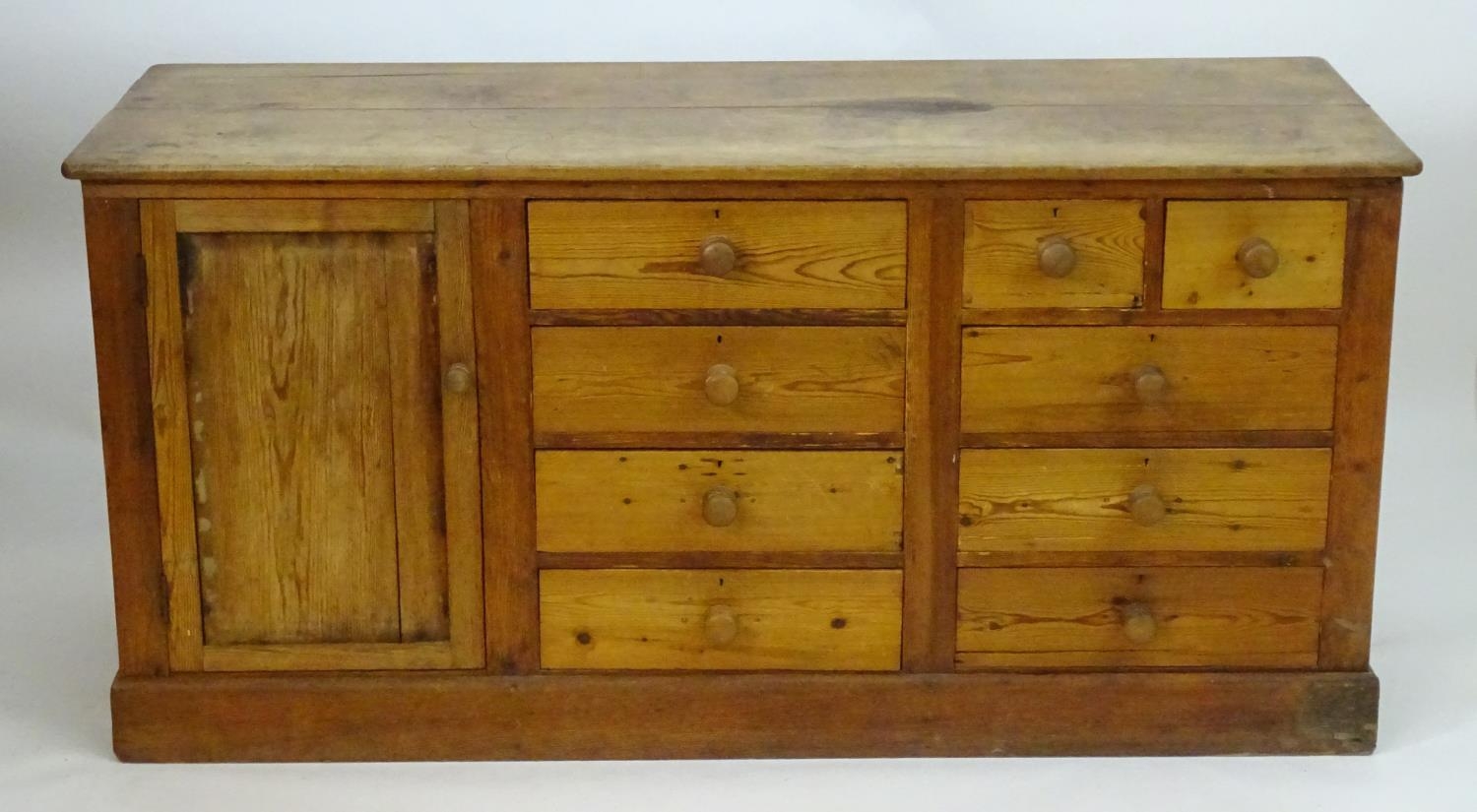 A late 19thC pine dresser base with a moulded rectangular top above a single cupboard, seven short - Image 2 of 7