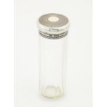 A glass toilet bottle with silver top, hallmarked London 1923, maker Mappin & Webb. Approx. 5 1/2"