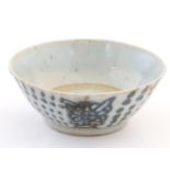 An Oriental earthenware bowl with brushwork detail. Floral motif under. Approx. 2" x 5 1/2" Please
