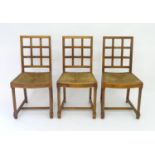 Three early 20thC oak Heals Tilden chairs with latticework backs, envelope rush sets and standing on
