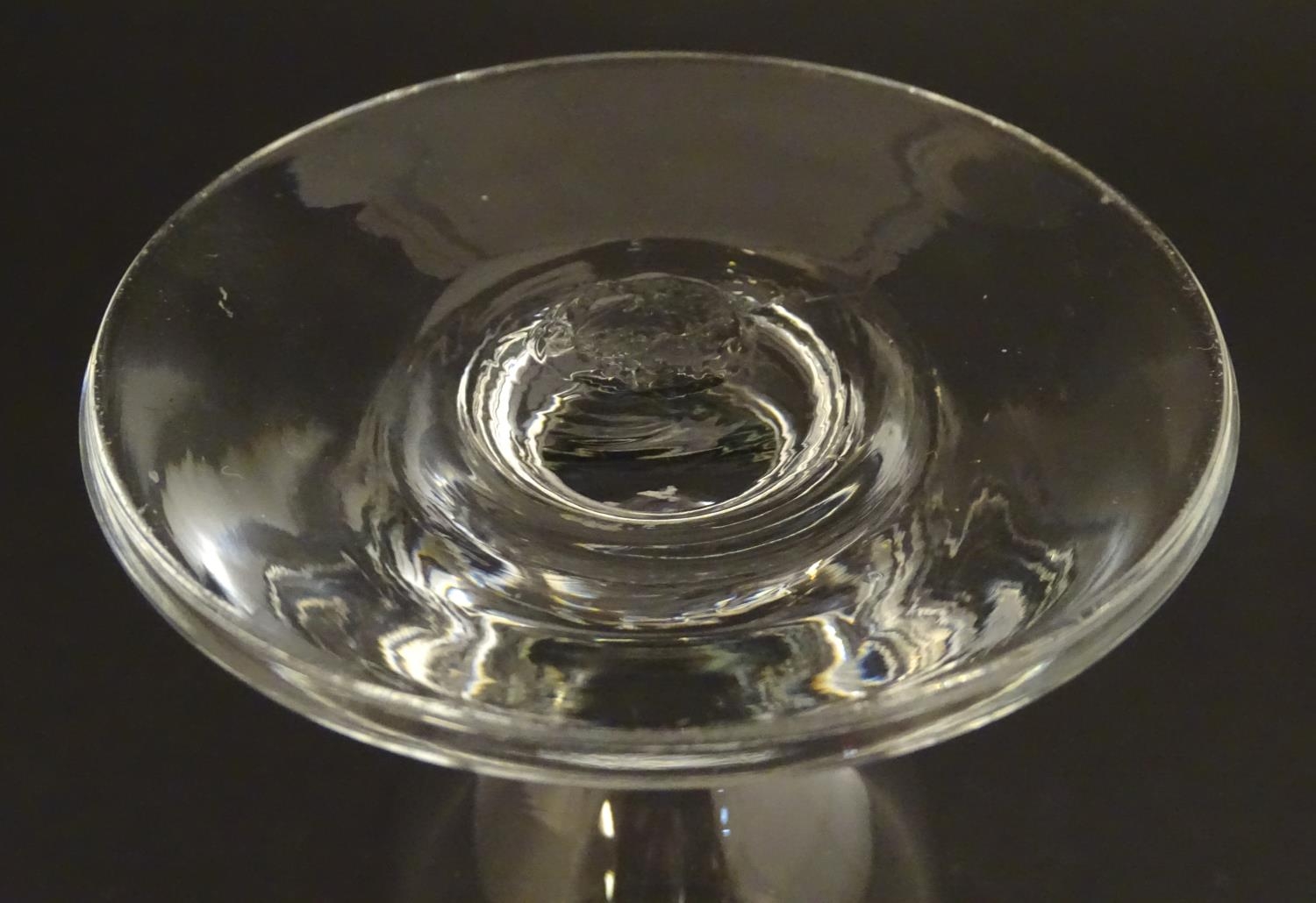 A drinking glass with wide foot. 4 1/2" high Please Note - we do not make reference to the condition - Image 2 of 5