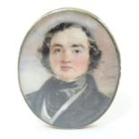 A 19thC watercolour portrait miniature depicting a gentleman in a black jacket and cravat, within an