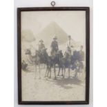 An early 20thC photograph depicting two British Army Infantry soldiers on camels in front of the