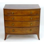 A mid 19thC mahogany serpentine chest of drawers with a moulded top above four long drawers with