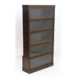 An early 20thC oak stacking 'Meovoto' bookcase with five tiers having sliding glass doors. 34"