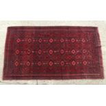 Carpet / Rug : A Red ground rug with central banded medallions and gyrometric borders. Approx 99"