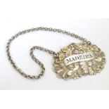 A Victorian silver decanter / wine label / bottle ticket with fruiting vine detail engraved Madeira,