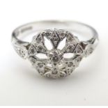 A 9ct white gold and diamond ring set with 19 diamonds with a profusion of diamonds, with further
