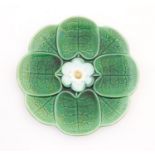 A majolica plate with stylised water lily flower decoration. Approx. 7 3/4" diameter Please Note -