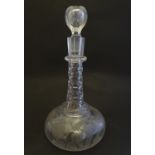 A Victorian glass onion decanter, profusely decorated with etched creeping vines, flowers, phoenix
