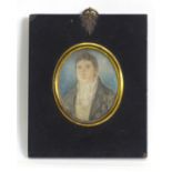 An early 19thC oval watercolour and body colour portrait miniature depicting a gentleman wearing a