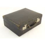 An early to mid 20thC Gentleman's travelling case, with black leather exterior, the interior with