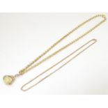 A 9ct gold chain necklace 16" long together with a 9ct gold pendant fob set with rotating facet