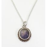 A silver pendant and chain, the pendant set with Blue John cabochon. Pendant approx. 1/2" long,