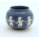 A Doulton Lambeth style circular pot with banded decoration depicting dancing children. Marked under