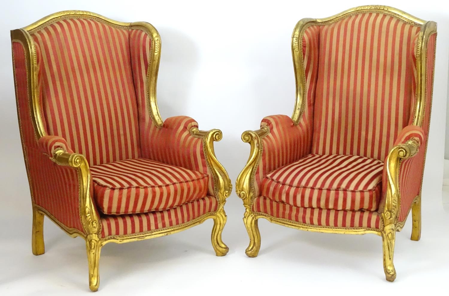 A pair of mid 20thC large gilt wingback armchairs, having moulded frames with floral decoration, - Image 3 of 7