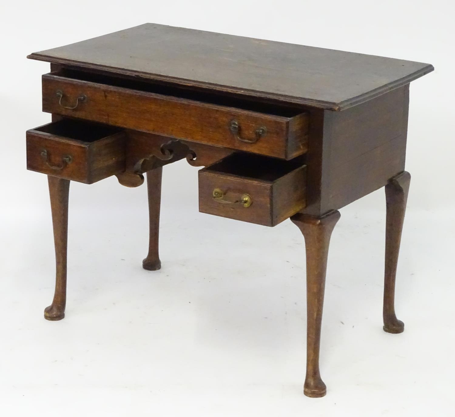 A mid 18thc oak lowboy with a moulded rectangular top above a single long and two short drawers with - Image 2 of 5