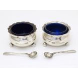 A pair of silver salts with blue glass liners and associated silver salt spoons, the salts