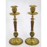 A pair of 19thC brass candlesticks with copper reeded columns. Approx. 10 1/2" high (2) Please