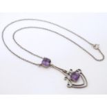 An early 20thC white metal pendant and chain, the pendant set with amethysts. Approx. 16" long