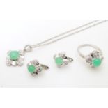 A silver suite of jewellery set with green cabochon and white stones, comprising ring, earrings