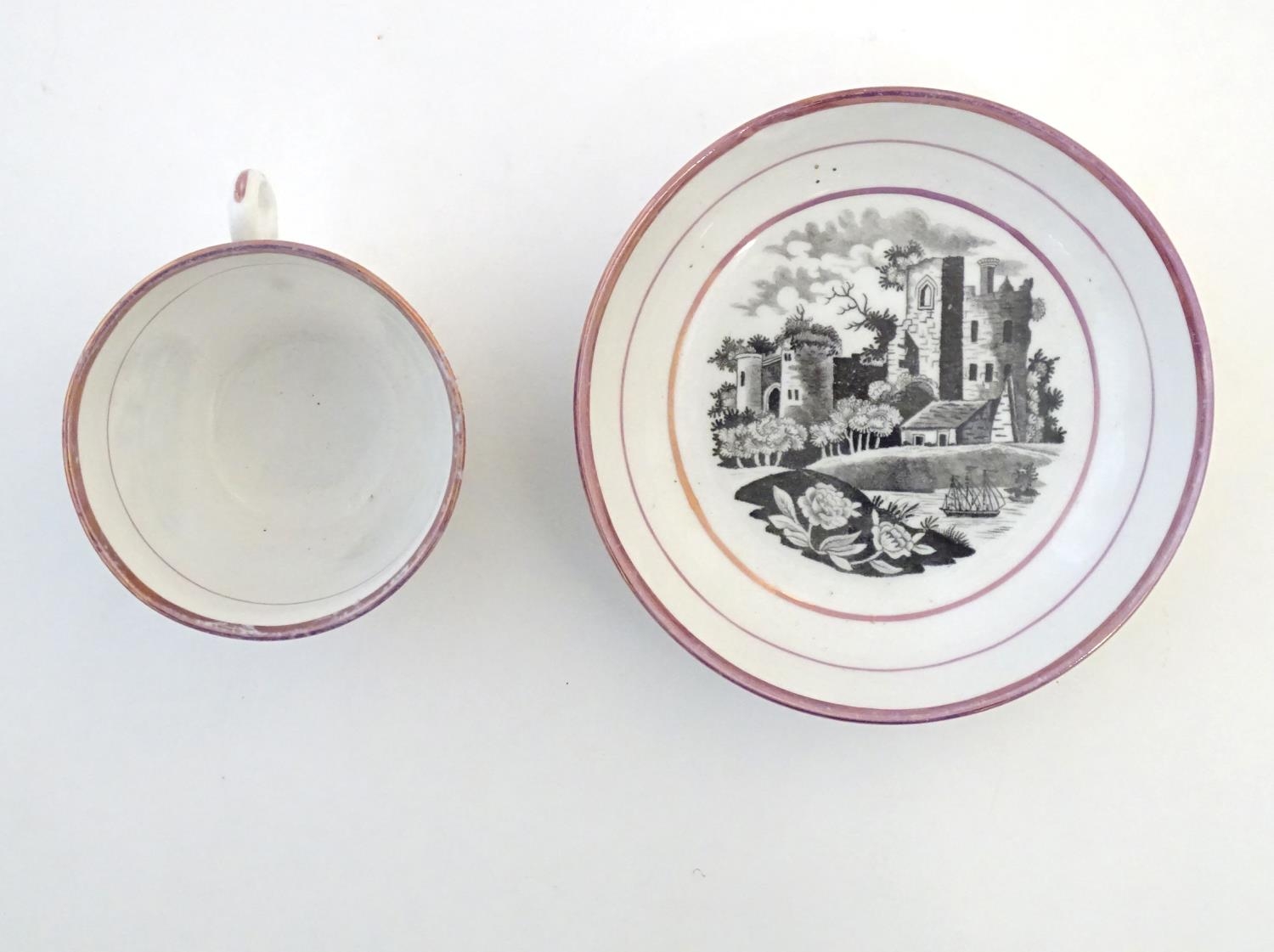 A tea cup and saucer with monochrome transfer decoration depicting a river landscape with a ship and - Image 4 of 6