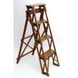 An early 20thC library step ladder, constructed from beech and ash with four steps, 14" wide, 44"