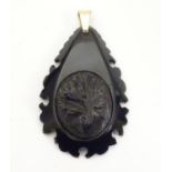 A carved jet pendant with foliate detail and 9ct gold loop. Approx. 1 3/4" long Please Note - we